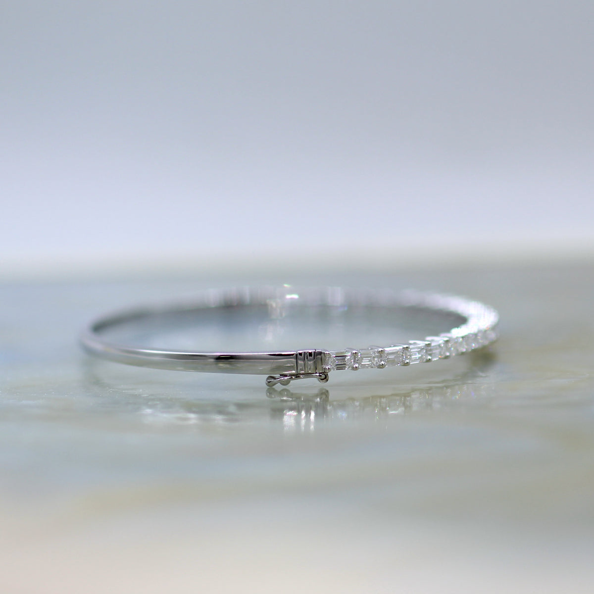 18K White Gold Hinged Bangle with Emerald Cut Diamonds